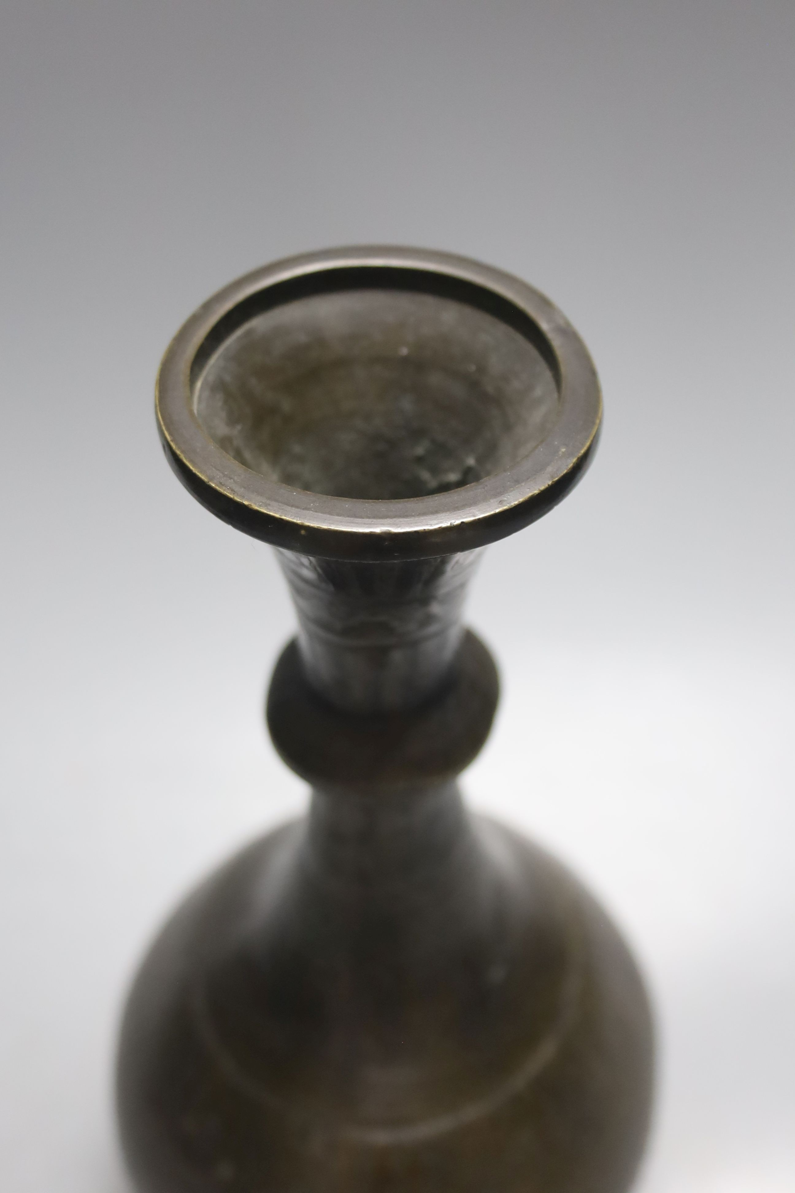 A Middle Eastern Islamic bronze vase, 28 cms high.